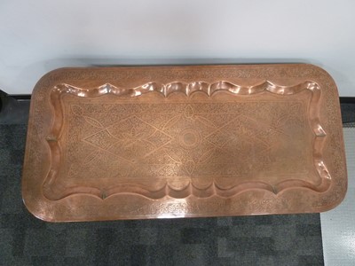 Lot 136 - A vintage Middle Eastern copper tray table top on hardwood stand