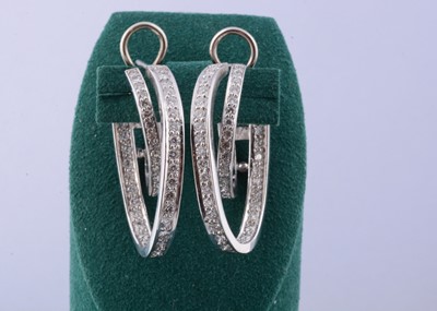 Lot 174 - A pair of continental 18ct gold diamond hoop earrings