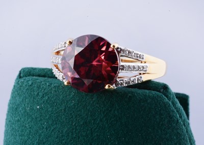 Lot 182 - An 18ct gold Lorique red zircon and diamond set dress ring