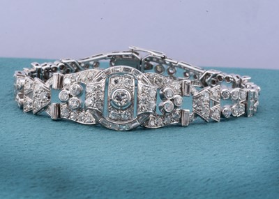 Lot 186 - An art deco platinum set diamond bracelet of architectural pierced design