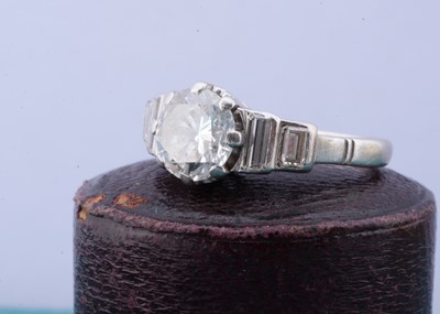 Lot 196 - An art deco platinum and diamond step cut solitaire dress ring