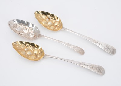 Lot 366 - A pair of George III silver berry spoons and another