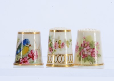 Lot 427 - Three hand painted porcelain thimbles