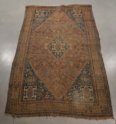 Lot 409 - A worn and faded Persian woollen rug