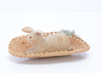 Lot 180 - An early brushed cotton rabbit in a basket pin cushion, circa 1910