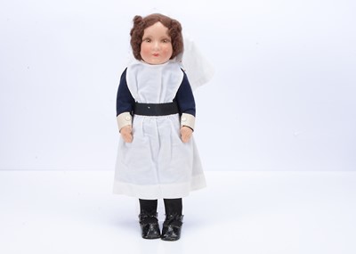 Lot 519 - A cloth doll dressed as a nurse