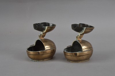 Lot 231 - Two Chinese brass travel candlesticks