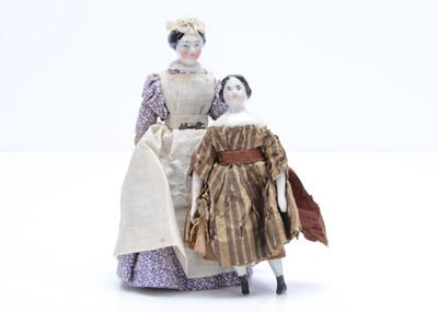 Lot 671 - Two German 19th century china shoulder-head dolls’ house dolls