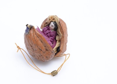 Lot 688 - An 19th century china Frozen Charlotte doll in a walnut shell