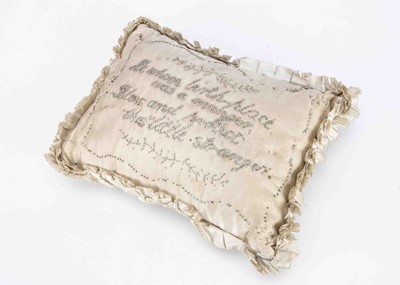 Lot 842 - An 19th century or earlier cream silk christening layette pincushion