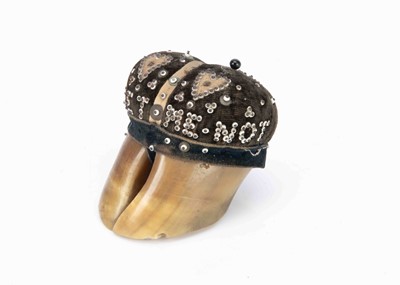 Lot 844 - A late 19th century pinned bead and hoof pincushion