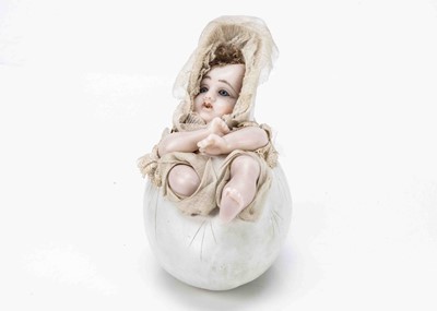 Lot 899 - A German wax baby in egg candy containers circa 1910