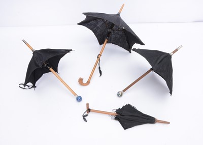 Lot 975 - Four small doll’s umbrellas