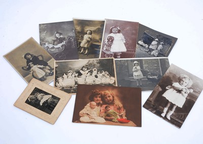 Lot 1017 - One hundred and sixty real photographs of children featuring with dolls and toys