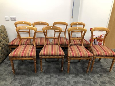 Lot 338 - A set of eight hardwood balloon back dinning room chairs