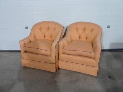 Lot 348 - A pair of apricot coloured upholstered armchairs with blue piping