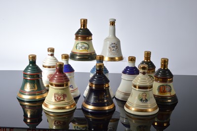 Lot 94 - A collection of twelve Bell's Whisky Christmas and Commemorative Wade bell decanters and contents