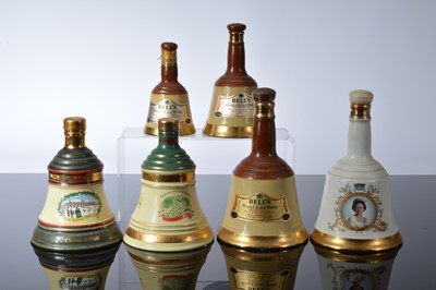 Lot 100 - Six Bell's Whisky Wade Pottery bell commemorative decanters and contents