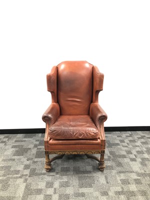 Lot 359 - An early 20th century leather wingback armchair