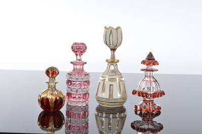 Lot 102 - Four pretty cut glass scent bottles