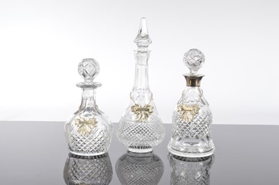 Lot 106 - Three cut glass decanters and silver labels