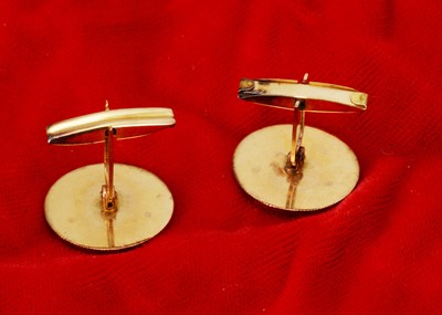 Lot 208 - A pair of Bahrain yellow metal and enamel snap cufflinks