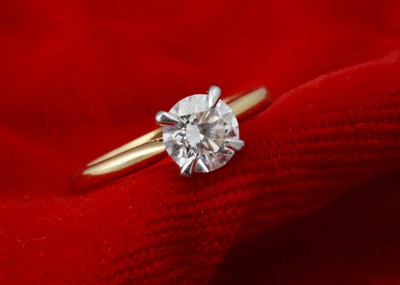 Lot 225 - A GIA certificated diamond solitaire 18ct gold and platinum set ring