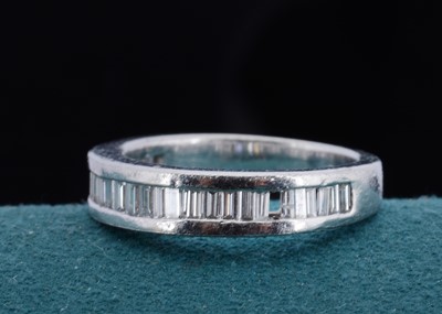 Lot 10 - A platinum diamond half hoop eternity ring