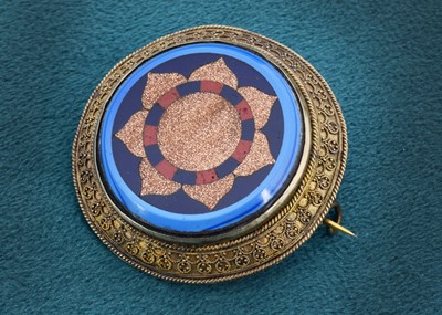 Lot 15 - A 19th century inlaid and base metal target brooch of circular design