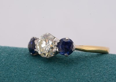 Lot 171 - A three stone diamond and sapphire ring