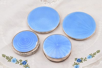 Lot 270 - Four silver blue guilloche enamelled circular compacts