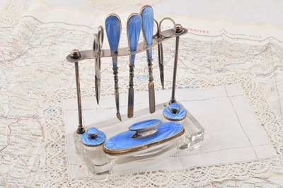 Lot 300 - A Walker and Hall Silver and blue guilloche enamelled manicure set on stand