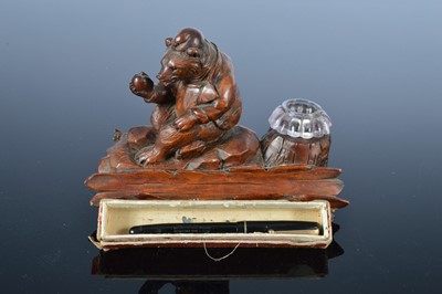 Lot 462 - An early 20th century Black Forest carved wooden ink stand and a Swan fountain pen