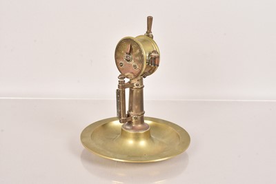 Lot 674 - An early 20th Century Brass Cigar Cutter and Ashtray