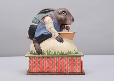 Lot 8 - An early 20th century Thüringen dressed Easter rabbit riding an egg eating a radish crank handled ‘eater’