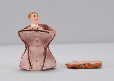 Lot 21 - A late 19th century novelty gentleman popping up from a pink silk corset