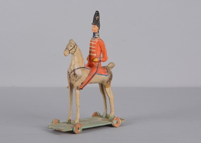 Lot 75 - A mid 19th century Thüringen composition and wood British mounted soldier pull along toy