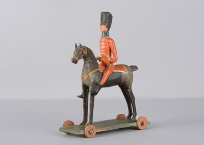 Lot 76 - A mid 19th century Thüringen composition and wood British mounted soldier pull along toy