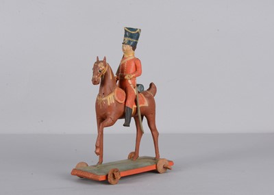 Lot 80 - A mid 19th century Thüringen composition and wood British mounted soldier pull along toy