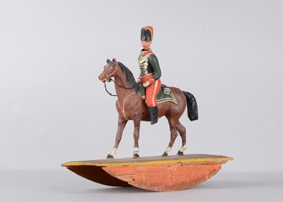 Lot 82 - A mid 19th century Thüringen composition Soldier on horse rocking toy