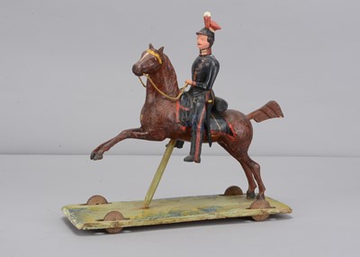 Lot 83 - A second quarter of 19th century Thüringen composition Soldier on horse pull along toy