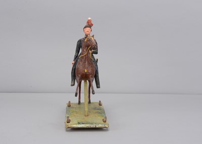 Lot 83 - A second quarter of 19th century Thüringen composition Soldier on horse pull along toy