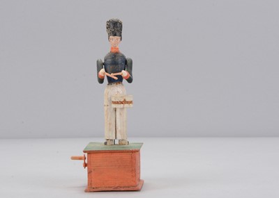 Lot 89 - A mid 19th century Thüringen composition headed and wood hand cranked drummer boy toy