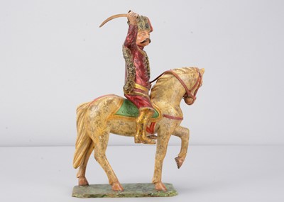 Lot 93 - A mid 19th century Germany carved wooden mounted red Hussar, possibly Oberammergau