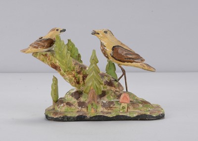 Lot 129 - A carved wooden group of two birds on a tree stump