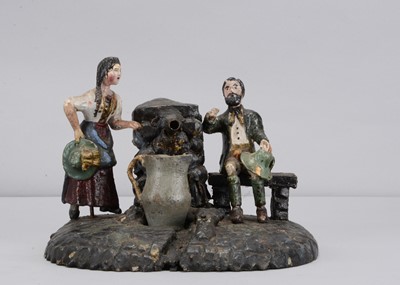 Lot 183 - A mid 19th century carved wooden man and woman at a spring