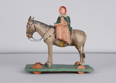 Lot 184 - A mid 19th century Thüringen composition woman riding a donkey side saddle pull along toy