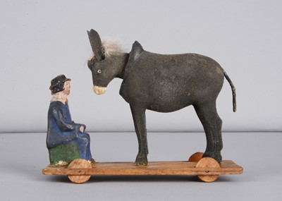 Lot 188 - A mid 19th century Thüringen composition man feeding his nodding donkey pull along toy