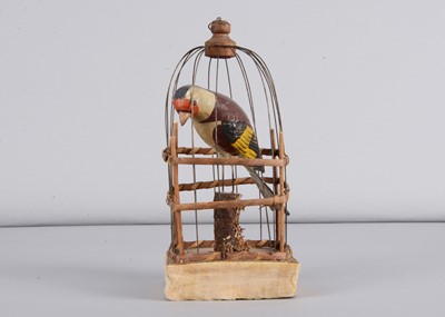 Lot 202 - A mid 19th century Thüringen squeak toy of a Goldfinch in cage