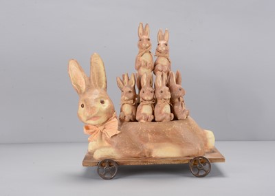 Lot 240 - A set of French papier-mâché rabbit skittles in rabbit on wheeled holder, circa 1900